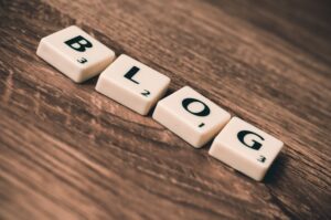 The word blog spelled out on a wooden table, providing information about the business.